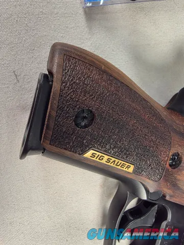 9488  Sig Sauer P229, 40 S+W, 3” Barrel, Night sights, 3-12 Round Magazines, Wood grips on it, with extra rubber grips. Can m