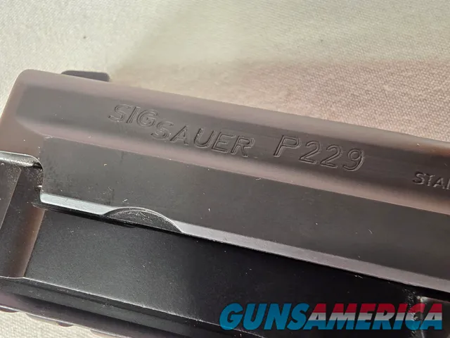 9488  Sig Sauer P229, 40 S+W, 3” Barrel, Night sights, 3-12 Round Magazines, Wood grips on it, with extra rubber grips. Can m