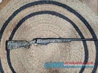 Camo bolt-action hunting rifle with iron sights