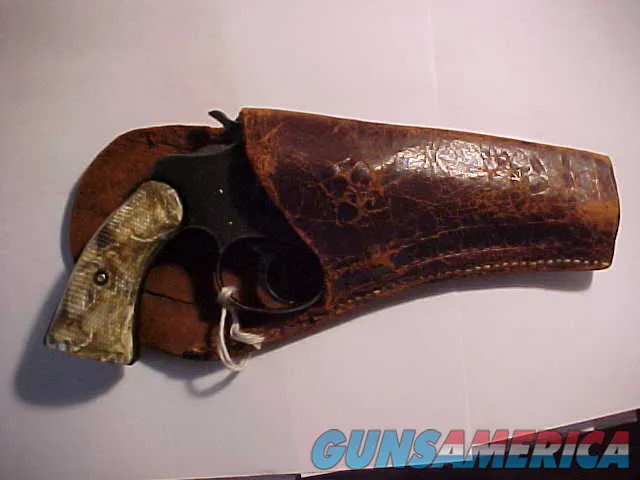 Vintage blued double-action revolver with holster