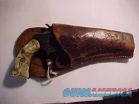 Vintage blued double-action revolver with holster